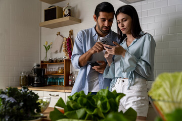 Attractive young couple have spending romantic time together in kitchen at home