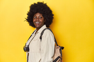 Stylish African-American woman with vintage camera Stylish African-American woman with vintage camera.looks aside smiling, cheerful and pleasant.