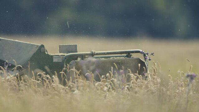 Tractor Mowing Long Grass, Close Up of Blades, Shallow Depth of Field, Slow Motion Close up