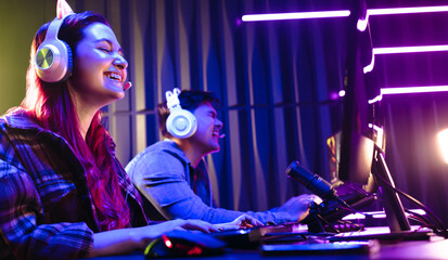 Female gamer enjoying her victory in a gaming contest against a male player © Jacob Lund