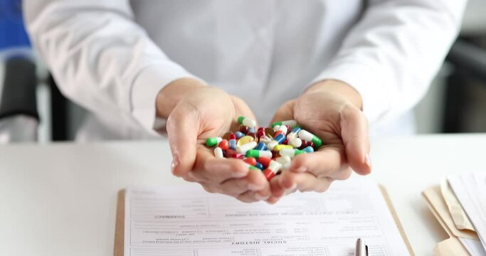 Doctor has many multi-colored pills in hands. Pharmacy drugs concept