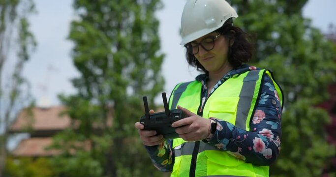 Female engineer with remote control for Mavic 3E professional photogrammetry drone