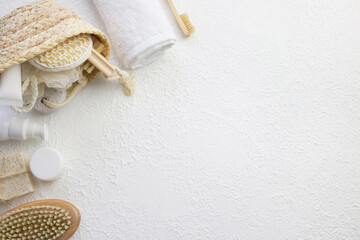 Cosmetic, massage and bath accessories set on white texture background