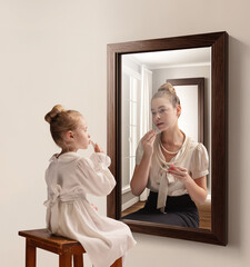Creative conceptual collage. Little girl looking in mirror and seeing reflection of young girl, her...