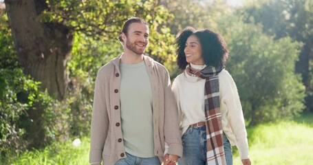 Interracial, couple and walking in park for love, care and relax on romantic date together in nature. Happy man, young woman or strolling in sunshine, spring garden or freedom of quality time outdoor - Powered by Adobe