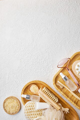 Spa and bathroom accessories on wooden tray, brush, oil, cream