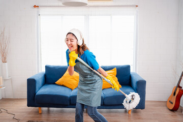 Happy Housework or house keeping service female singing and cleaning dust in house, cleaning agency small business. professional equipment cleaning old home.