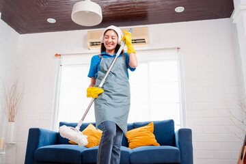 Happy Housework or house keeping service female singing and cleaning dust in house, cleaning agency small business. professional equipment cleaning old home.