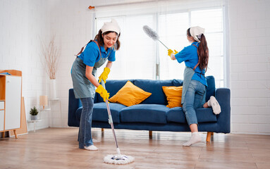 Housework or house keeping service two female cleaning dust in home, cleaning agency small business. professional equipment cleaning old home.