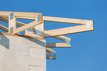 Fototapeta premium New residential construction home framing against a blue sky