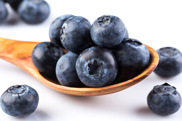 Fresh blueberries in wooden spoon