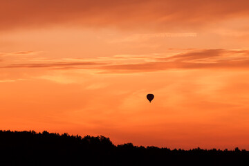 Hot air balloon flying at sunset sky