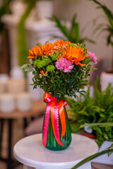 Bouquet with gerberas and other flowers in a vase