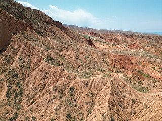 
Top view, bird's eye view, Skazkak valley in Kyrgyzstan, chalk mountains with dried up river and grass