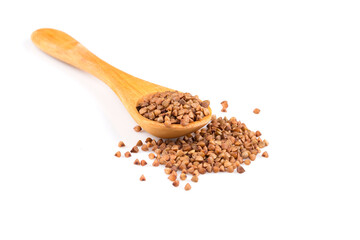 Uncooked buckwheat on wooden spoon