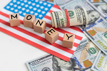 wooden cubes tax with flag, dollar, coin and calculator on orange background