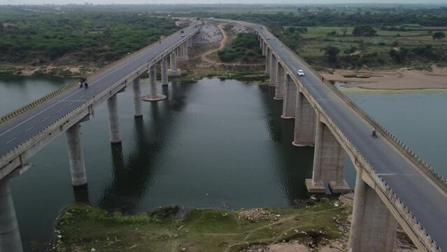 Highway bridge built over the river basin in the Indian rural terrain, Aerial view