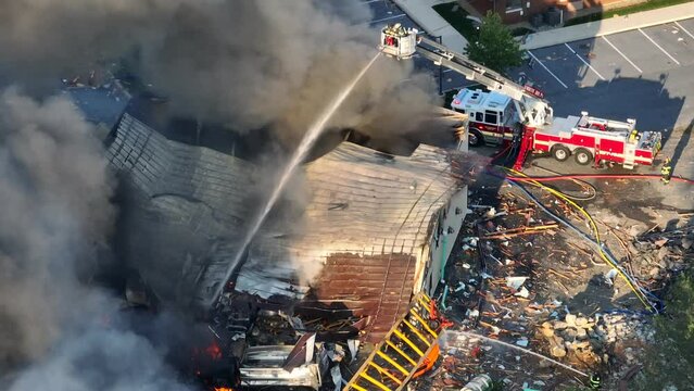 Firefighter on ladder Extinguish fire after gas explosion during daytime - Dark Dense Fumes rising up