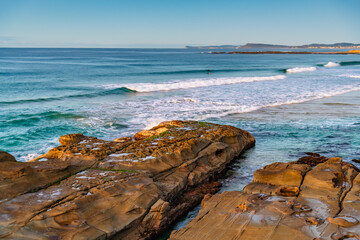 Sunrise seascape with rock platform