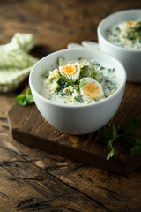 Traditional homemade cold soup with yogurt and herbs