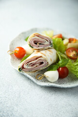 Ham and cream cheese rolls served with vegetables