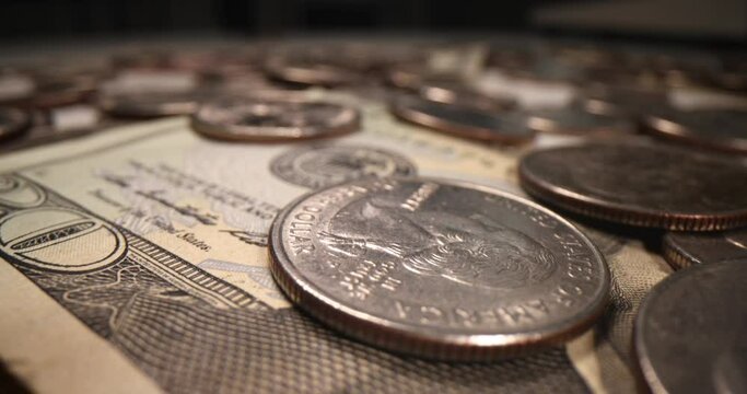 Many coins and dollar bills closeup 4k movie slow motion. Cash savings concept