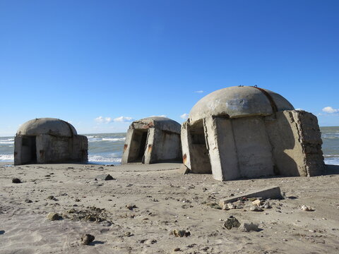 Albanian concrete pillbox bunkers standing empty on seaside, being abandoned