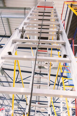 Aluminum one-sided ladders indoors close-up.