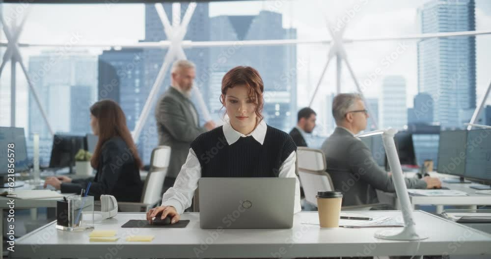 Poster beautiful caucasian woman working on laptop computer in bright office in urban skyscraper office in 