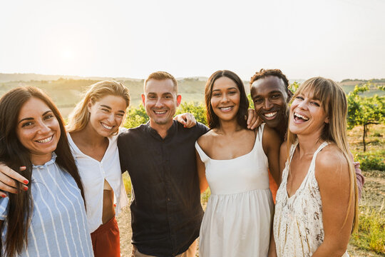 Happy multiracial friends having fun outdoor with vineyards in background - Tourist multi ethnic people smiling on camera during summer vacation - Travel, friendship and summer holidays concept