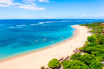 Seashore with palm trees and cafes. Coast as a background from top view.  Aerial landscape. Background from drone. Summer seascape from air. Vacation time.