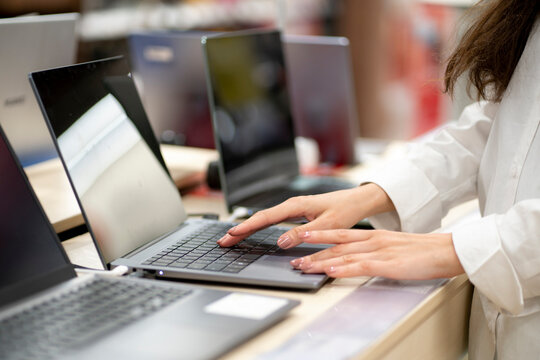client in a retail shop choosing a new laptop for studying and working