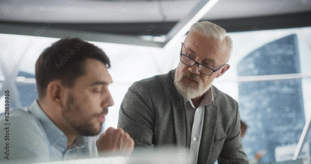 Poster close up of succesful caucasian male lawyer talking to young law intern behind laptop computer in sk