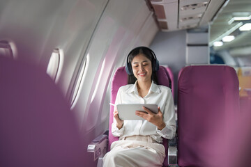 Plane passenger business woman working in airplane cabin during flight with in flight wifi typing...