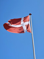 Danish flag Dannebrog in front of a blue sky