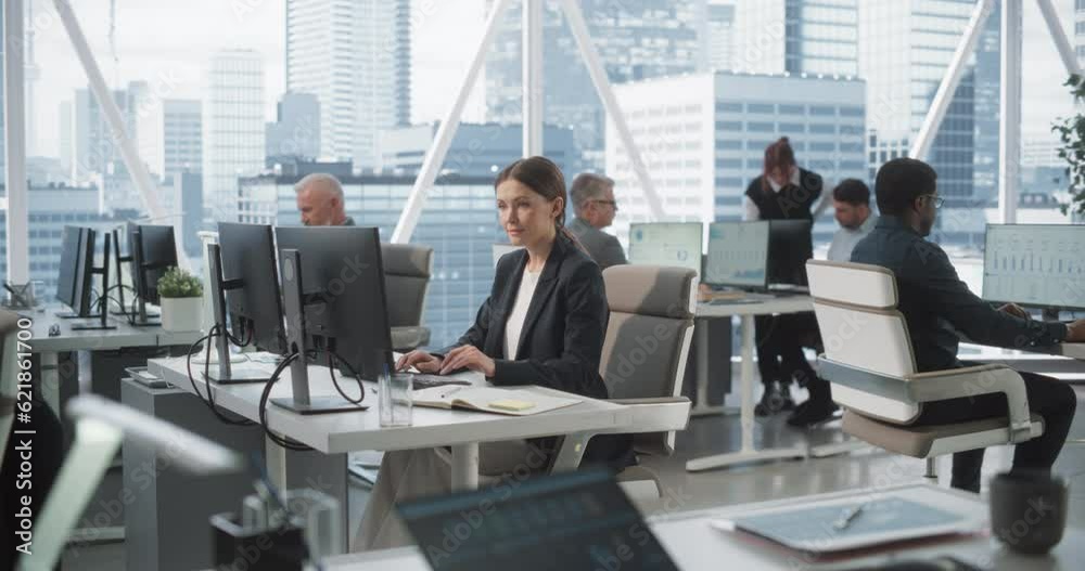 Poster Focused Female Data Analyst Typing On Desktop Computer In Bright and Diverse Corporate Office With Megapolis Window View. Professional Caucasian Woman Working In Consulting Company With Colleagues.