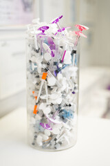 many syringes for cosmetic surgery in a large transparent box