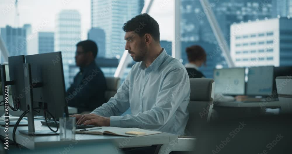 Poster Male Account Manager Typing On Desktop Computer In Diverse Corporate Office With Megapolis Window View. Professional Caucasian Man Creating Report For Consulting Company. Dramatic Evening Edit.