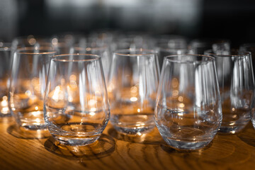 empty clean glass glasses for alcoholic drinks in a restaurant on a bar counter