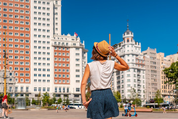 Young tourist woman in Spain square in the center of Madrid capital enjoying vacations in summer