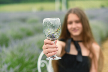 Beautiful girl with long hair in a lavender field. Beautiful girl in a hat. Summer in the lavender field