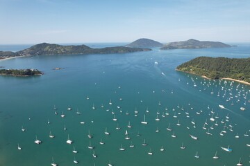 Drone view of Saco da Ribeira and Anchieta island. Ubatuba, Brazil. Port of sailboats and boats.