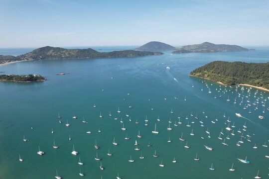 Drone view of Saco da Ribeira and Anchieta island. Ubatuba, Brazil. Port of sailboats and boats.