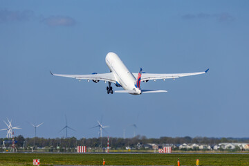Fototapeta na wymiar Passenger plane taking off from the runway, Schiphol, Amsterdam, The Netherlands