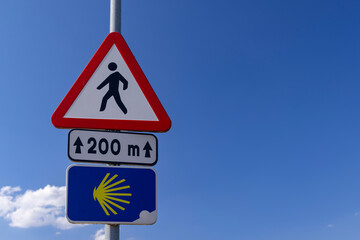 Road sign totem with yellow shell, that guides pilgrims along the Camino de Santiago