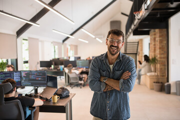 Portrait of a handsome young businessman in IT company - obrazy, fototapety, plakaty