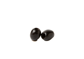 Tasty black olives isolated on white background. Olive and olive tree branches on a white table. Delicacy.