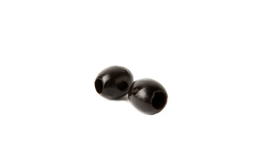 Tasty black olives isolated on white background. Olive and olive tree branches on a white table. Delicacy.