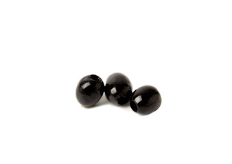 Tasty black olives isolated on white background. Olive and olive tree branches on a white table. Delicacy.