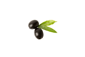 Tasty black olives isolated on white background. Olive and olive tree branches on a white table. Delicacy.